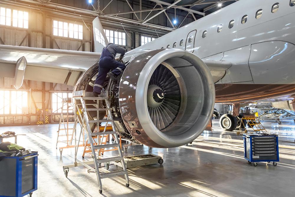 Technician working on aircraft engine