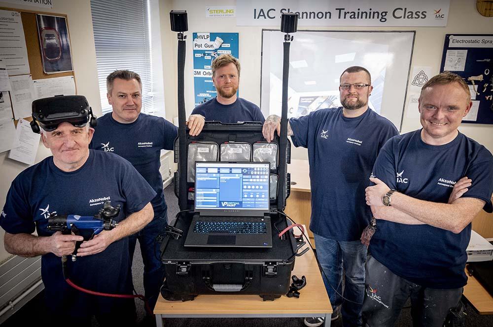 IAC employees with VR paint training system