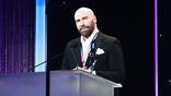 John Travolta at a podium