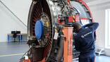 A Safran employee works on a CFM Leap-1A engine
