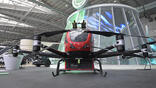 an adapted Chinese Ehang eVTOL aircraft equipped to fight urban blazes from above