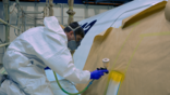 Aircraft painter spraying paint
