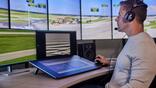 A controller monitors airport activity from a remote operations center.