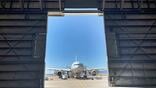 View of aircraft from inside hangar