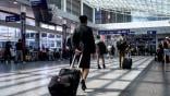 An Air Canada flight attendant walking through the airport.