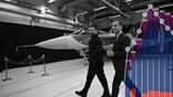 Swedish Prime Minister Ulf Kristersson (R) and Ukrainian President Volodymyr Zelensky walk past a Gripen fighter jet
