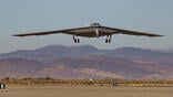 B-21 flying just above ground