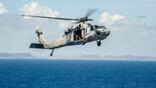 MH-60R Seahawk helicopter from the Saberhawks of Helicopter Maritime Strike Squadron (HSM) 77 prepares to land on the aircraft carrier USS George Washington (CVN 73) after delivering fresh water to the Republic of the Philippines in support of Operatio Contributor: MixPix