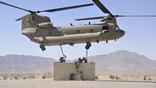Soldiers attached a Conex box to a CH-47 Chinook.