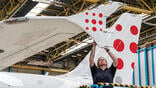 woman working on aircraft wing